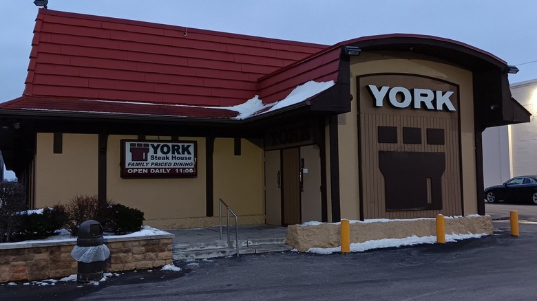 Exterior of York Steakhouse on a cloudy, overcast day with snow