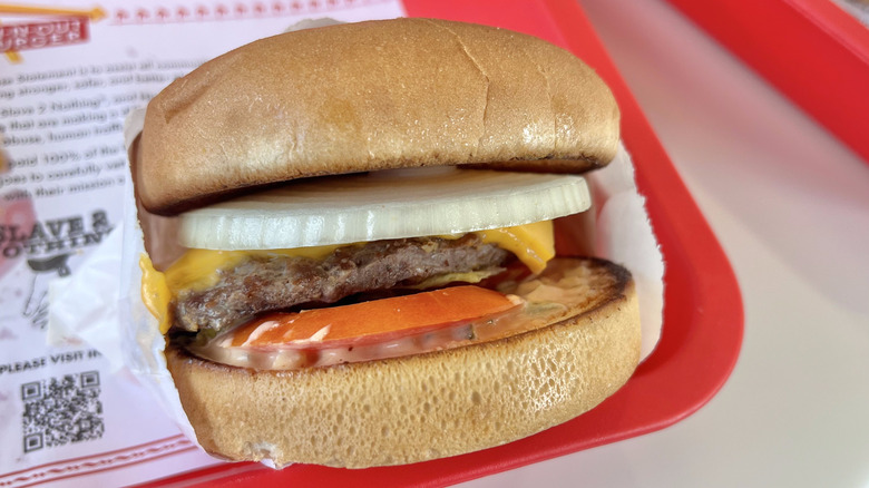 Close-up of a mustard grilled burger with onion