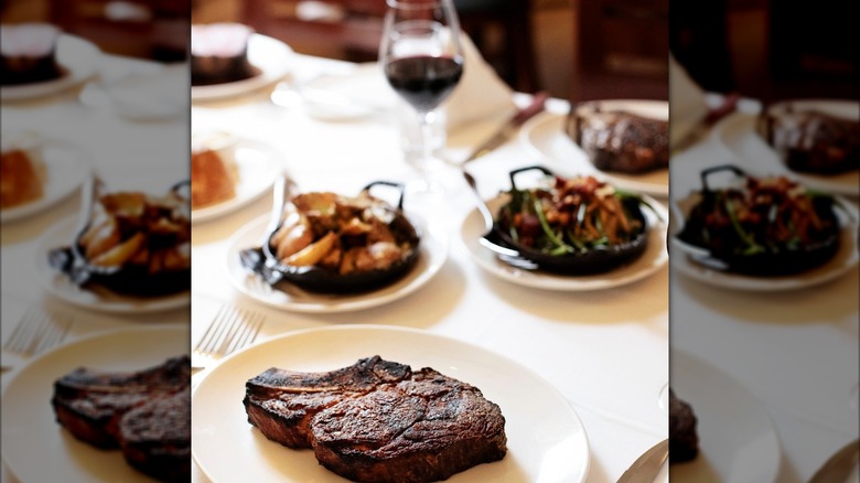 Steak and plate on table with blurred sides and wine