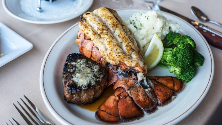 Surf-and-turf plate with lobster tail, filet, broccoli, and mashed potatoes