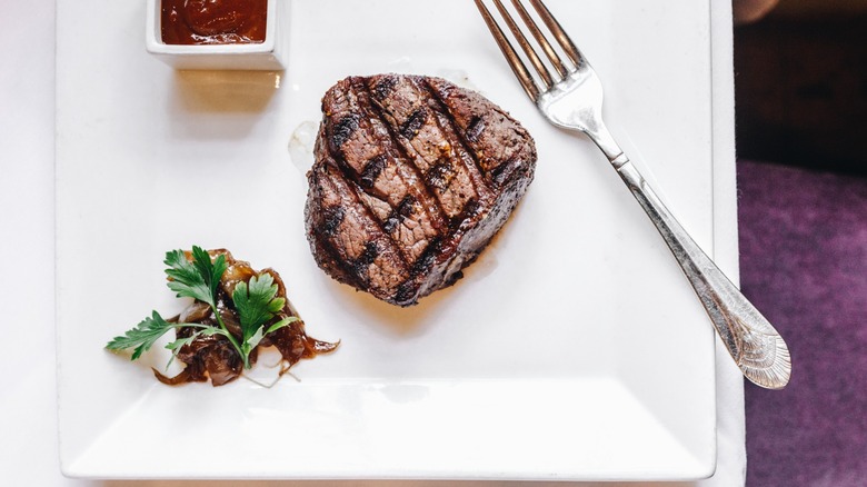 Steak on a plate with garnish and fork