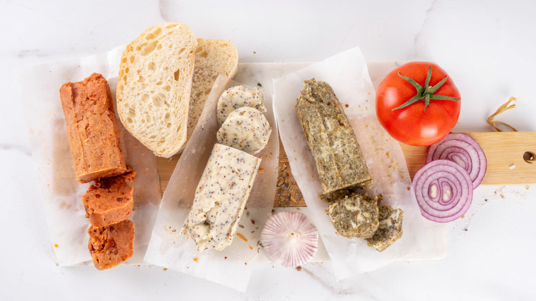 A variety of compound butters with garlic, herbs, and shallots.