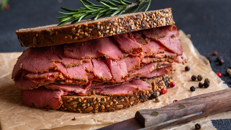 A pastrami sandwich on seeded rye bread.