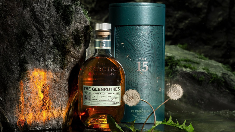 A bottle of The Glenrothes 15-year posed in a dimly lit rocky setting