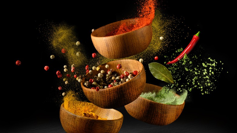 Various spices in wooden bowls
