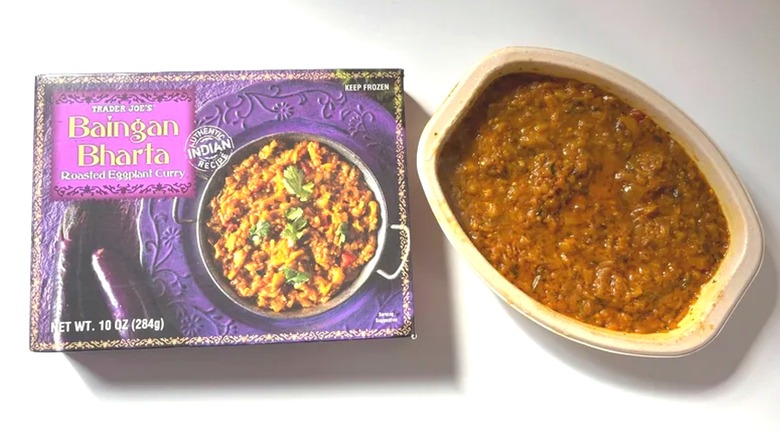 Trader Joe's Baingan Bharta box next to microwaved bowl on white surface