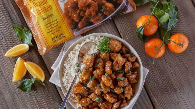 Bag of Trader Joe's Mandarin Orange Chicken above bowl of orange chicken and rice