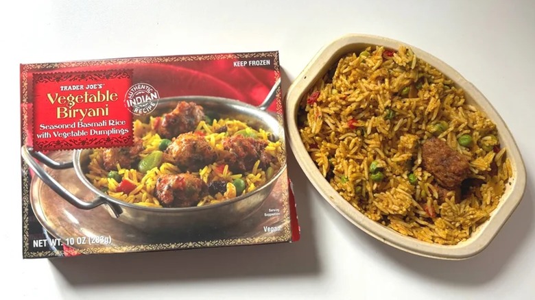 Trader Joe's Vegetable Biryani box next to microwaved bowl on white surface