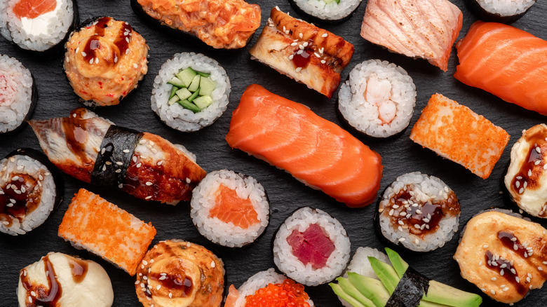 Assorted sushi on black background