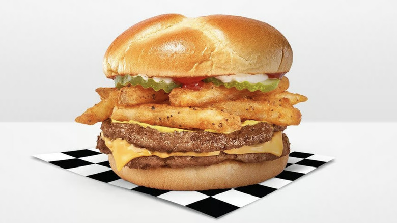 A Rally's Fry lovers cheeseburger on a checkerboard napkin