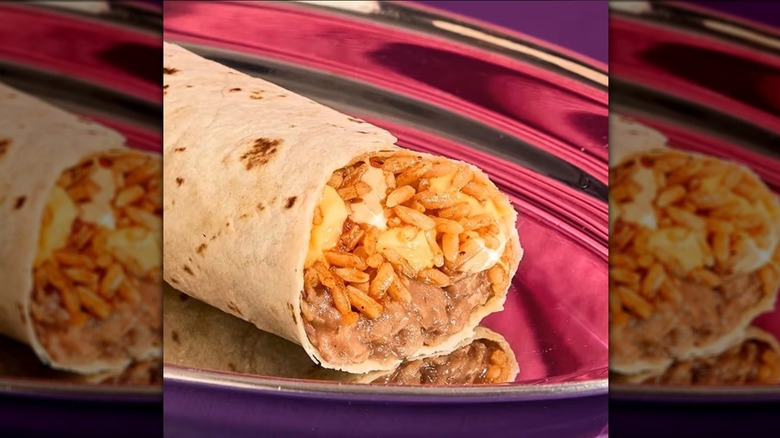Taco Bell cheesy bean and rice burrito sitting on a silver platter