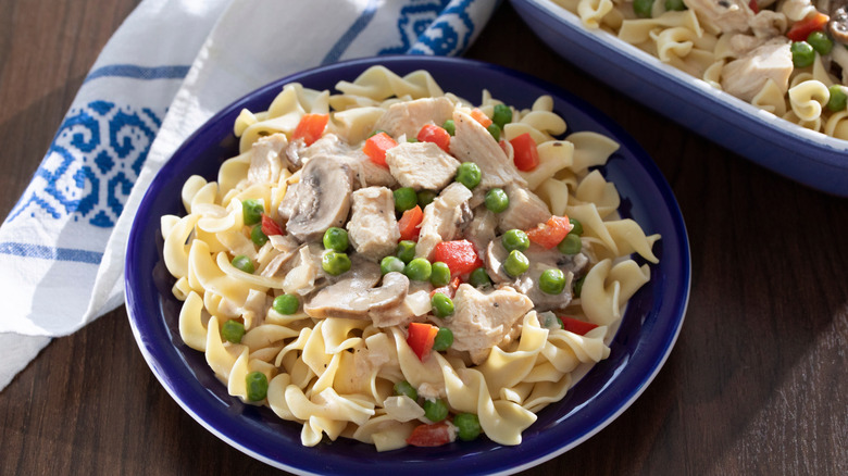 Chicken a la King served with noodles in a blue plate