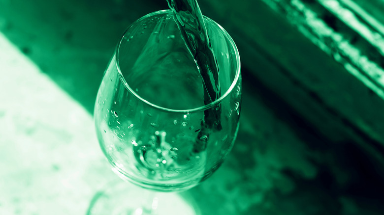 green wine poured in glass