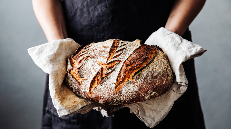 Person holding sourdough loaf