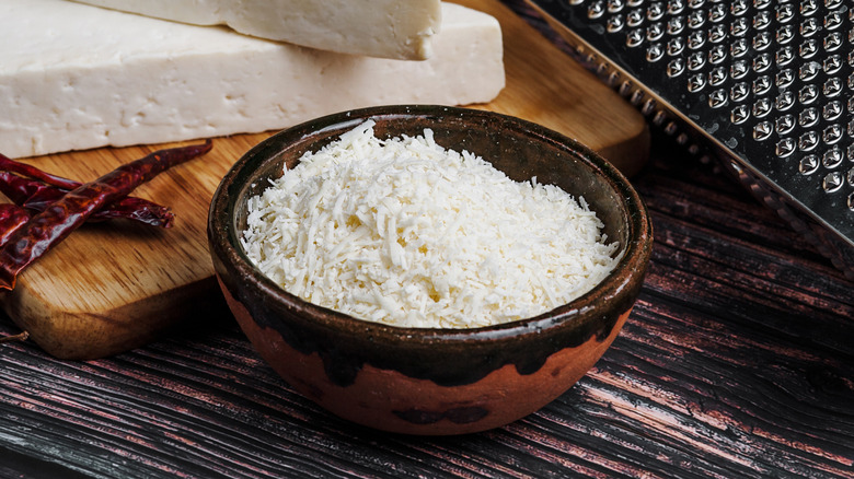 Finely shredded cotija cheese in bowl