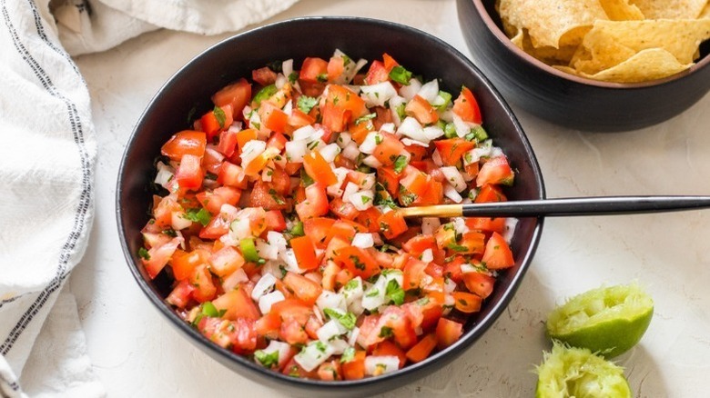 Fresh pico de gallo in black bowl
