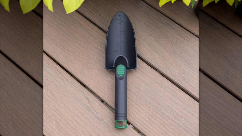 Black plastic garden trowel with green accents