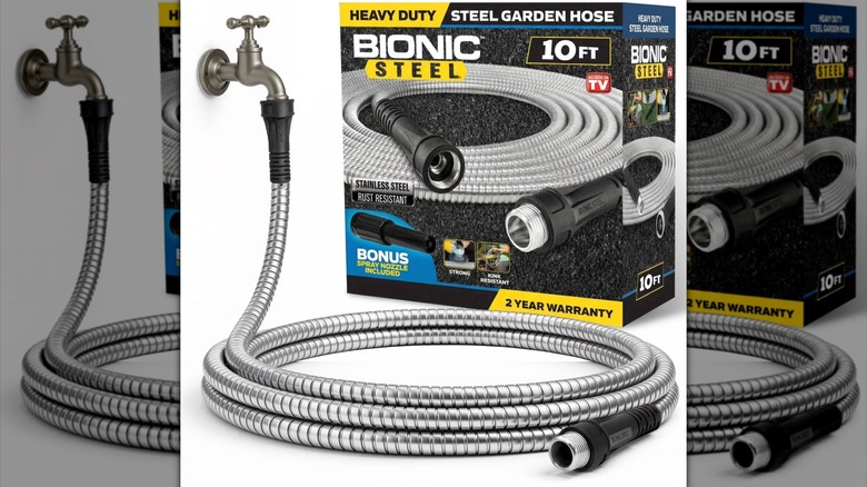 Steel watering hose hooked up to a pipe next to its product box