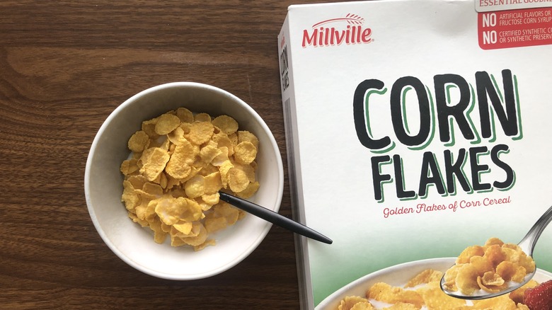 Bowlful of Millville Corn Flakes with milk and spoon.