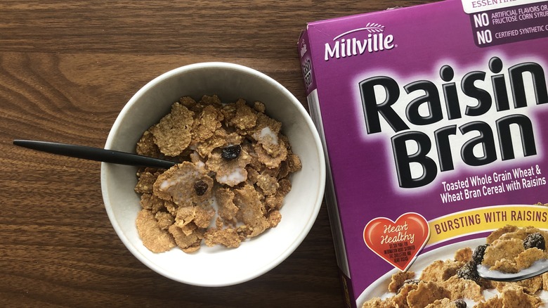 Bowlful of Millville Raisin Bran cereal with milk and spoon.