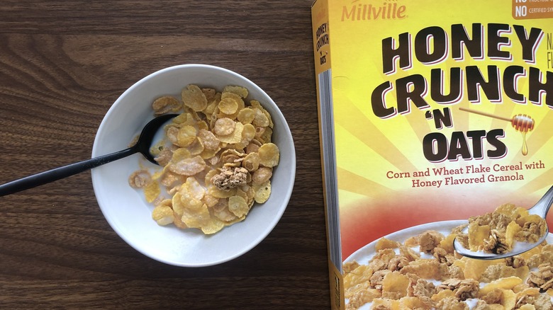 Bowlful of Millville Honey Crunch 'N Oats with milk and spoon.