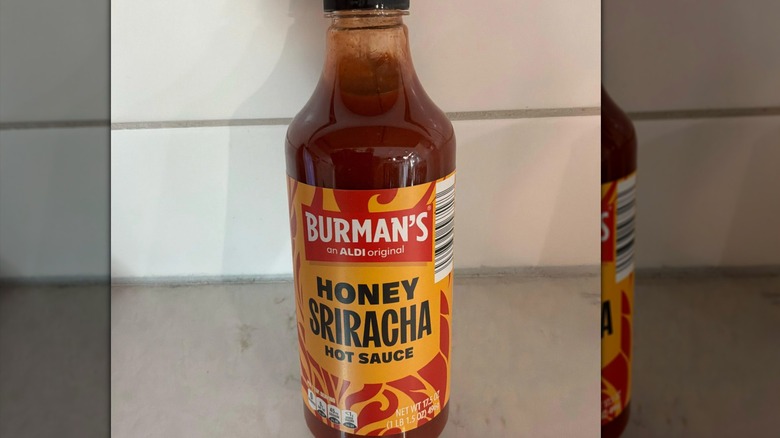 A bottle of Burman's Honey Sriracha Hot Sauce