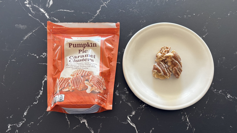 A bag of Choceur Pumpkin Pie Caramel Clusters next to the clusters on a white plate