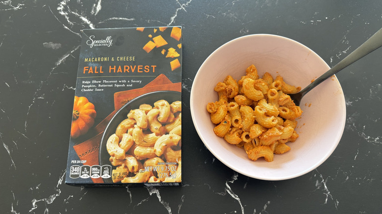 A box of Specially Selected Fall Harvest Macaroni & Cheese next to mac and cheese in a white bowl
