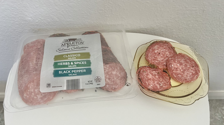 Trio of salami flavors in a plastic package and on a plate