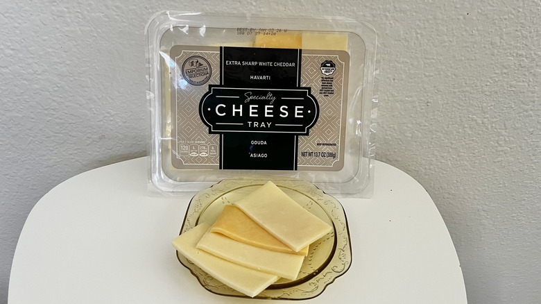 Cheese tray and cheese on a plate on a white table