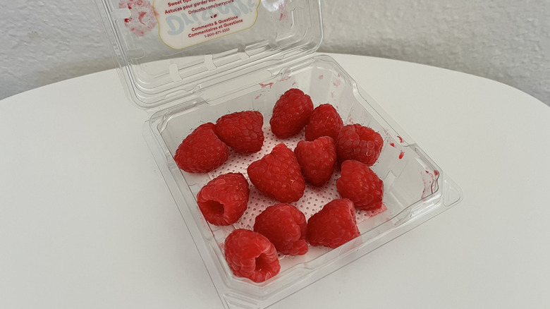 Close-up of fresh raspberries in a plastic container
