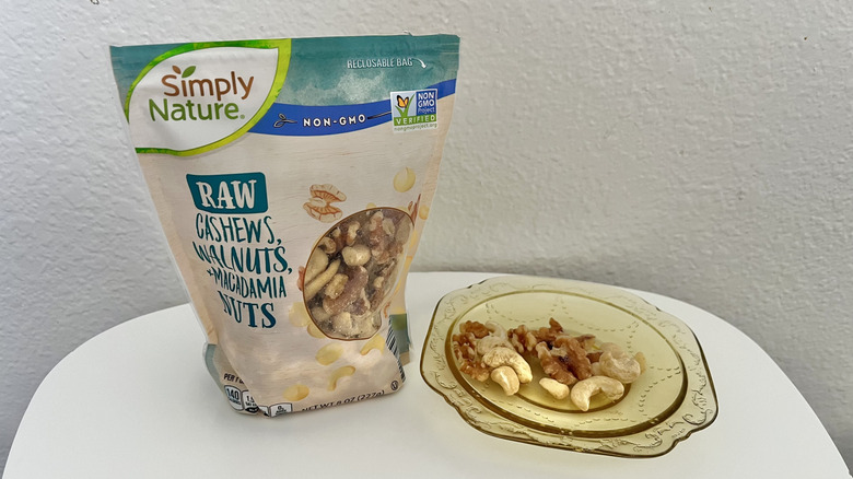 Cashews, walnuts, macadamia nuts in a bag and on a plate