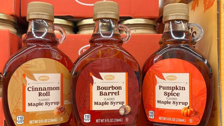 Three bottles of Aldi Berryhill Flavored Maple Syrup in seasonal flavors including Pumpkin Spice