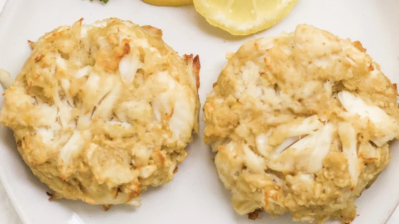 Two crabcakes on a white plate