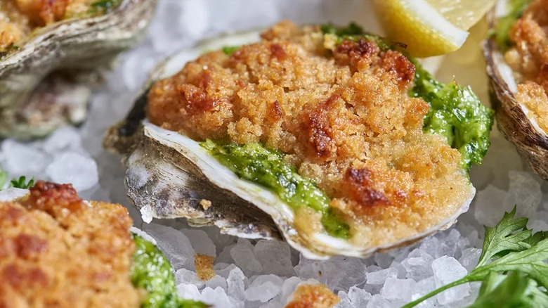 Closeup of a baked oyster Rockefeller on ice