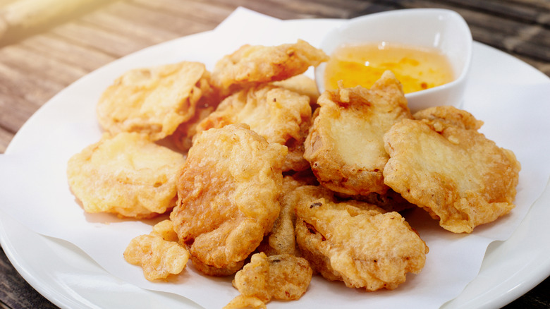 Fried mushrooms on plate with sauce