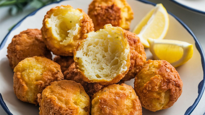 Plate of hush puppies with lemon wedge