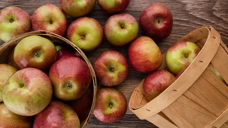 Whole Macoun apples spilling from a basket