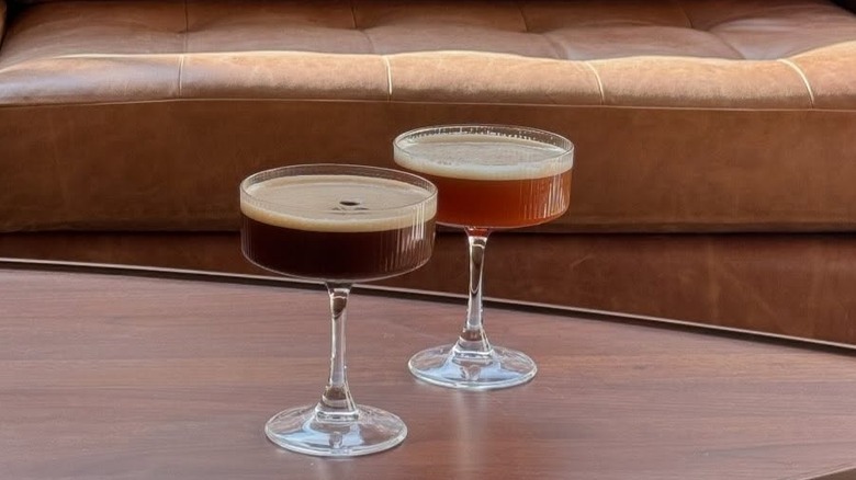 Two coffee mocktails on wooden table with leather couch in background at Big Shoulders Coffee