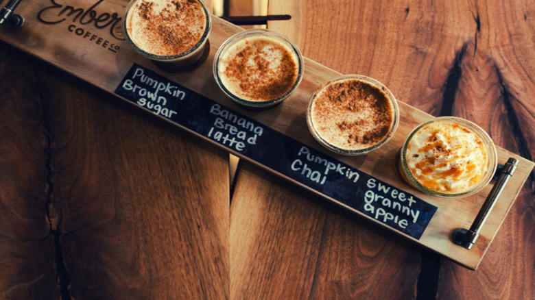 Four coffee drinks for fall on wooden table at Ember Coffee