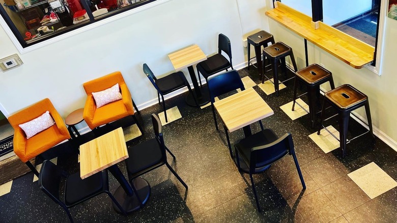 High-angle of empty tables, stools, and armchairs at Espresso Elevado