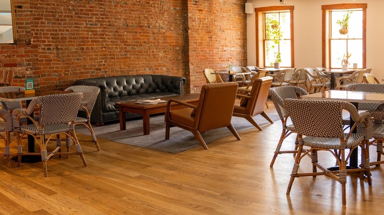 Interior of the Goshen Coffee St. Louis branch with brick wall and big windows