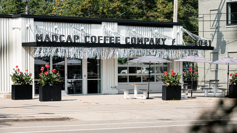 Madcap Coffee Company's white exterior view with flower planters in Grand Rapids