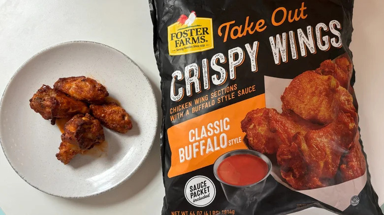 Foster Farms Buffalo take out crispy wings on a plate with a whole packaged bag next to the plate