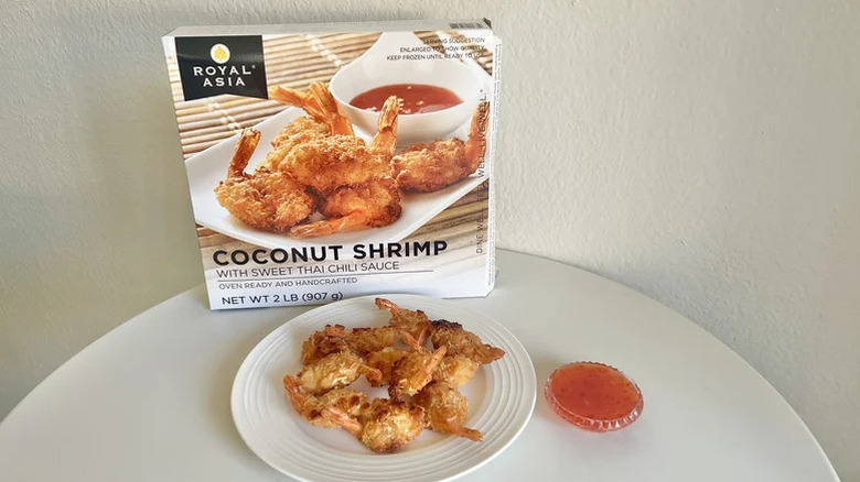 Royal Asia coconut shrimp pieces on plate with a whole box showcased in the background