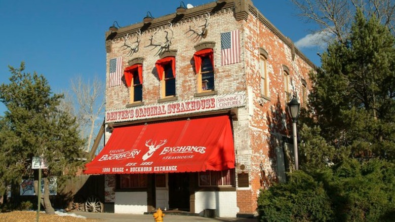 Exterior of the Buckhorn Exchange brick building with red awning