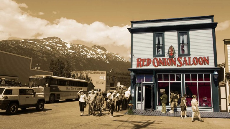 Sepia image of the street and exterior of the Red Onion Saloon with building in color