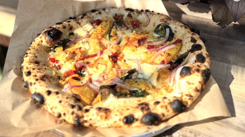Peach and onions on a pizza
