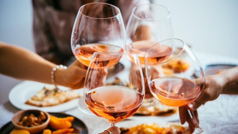 clinking rosé wine glasses