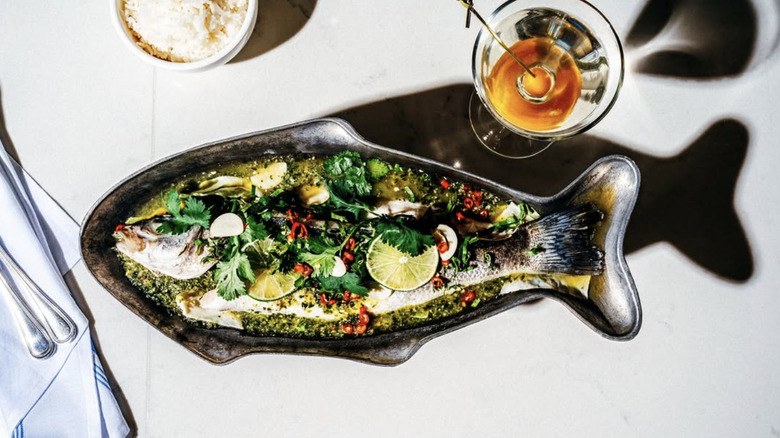 a branzino in a fish-shaped dish on a table